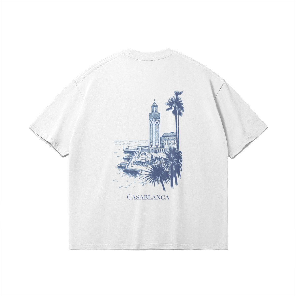 Back of white t-shirt featuring a detailed blue architectural sketch of the Hassan II Mosque and palm trees, minimalist luxury streetwear fit.