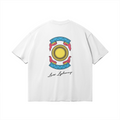 Back side of white graphic tee with a colorful traditional Moroccan Ronda card illustration (L'As d'Or) and 'Lass Lghenaz' script, boxy streetwear fit.