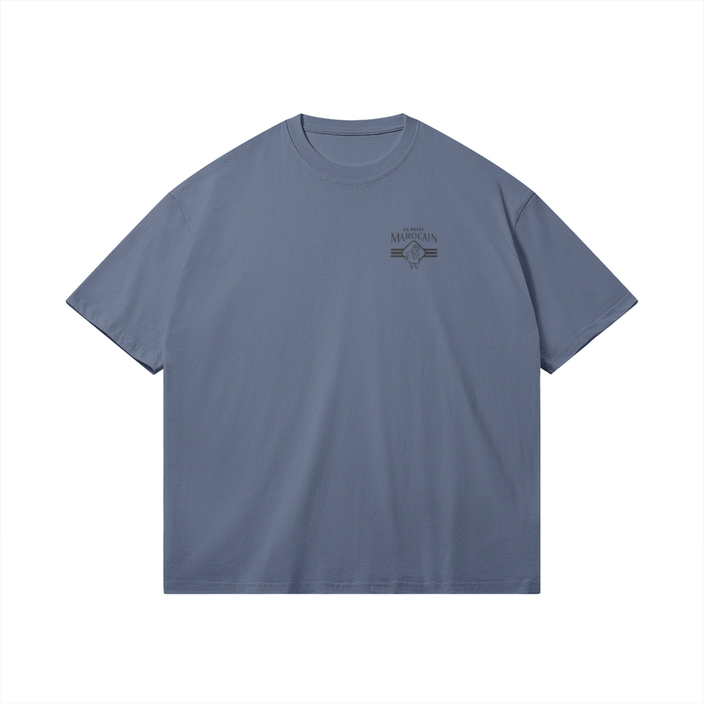 Front side of blue graphic tee with a colorful traditional Moroccan Ronda card illustration (L'As d'Or) and 'Lass Lghenaz' script, boxy streetwear fit.