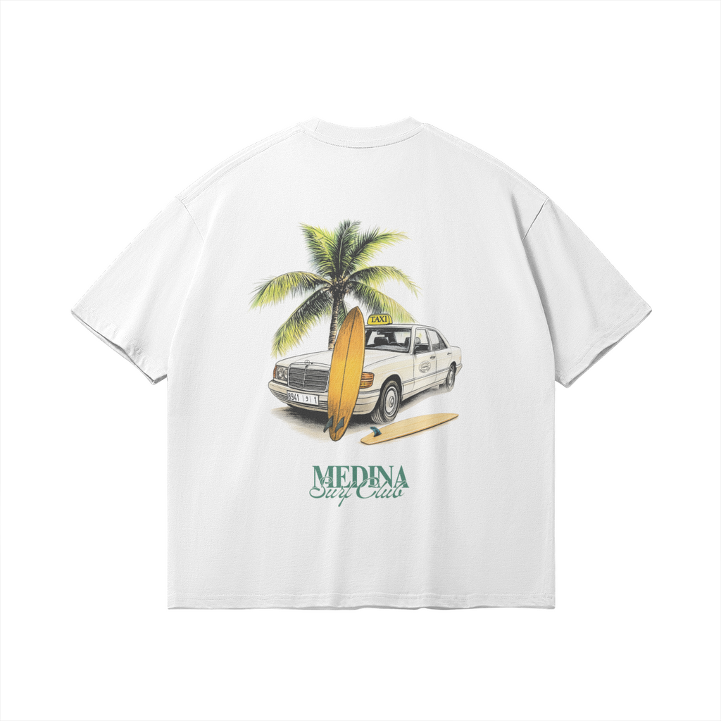 Back of white graphic tee featuring a vintage Grand Taxi Mercedes illustration with a palm tree and surfboards, 'Medina Surf Club' typography, retro Moroccan vibe.
