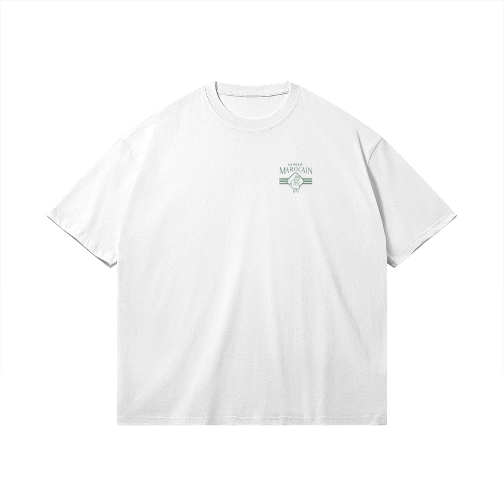 Front side of white heavyweight t-shirt featuring a retro cartoon mascot of a walking tagine with sunglasses, 'TAGINE CLUB' red text, and 'LE PETIT MAROCAIN' branding, vintage streetwear fit.